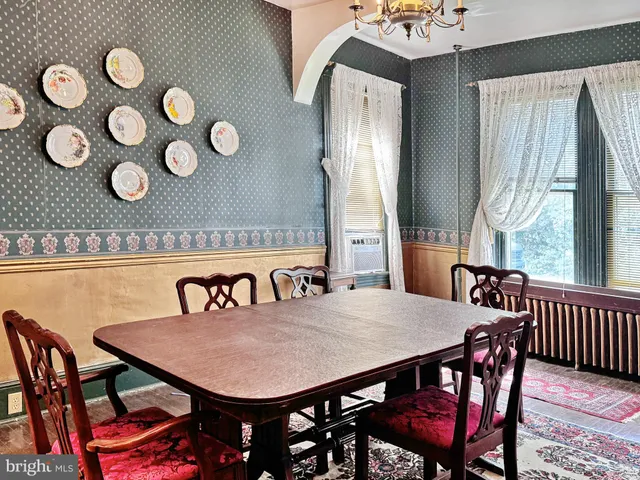 a view of a dining room with furniture and window