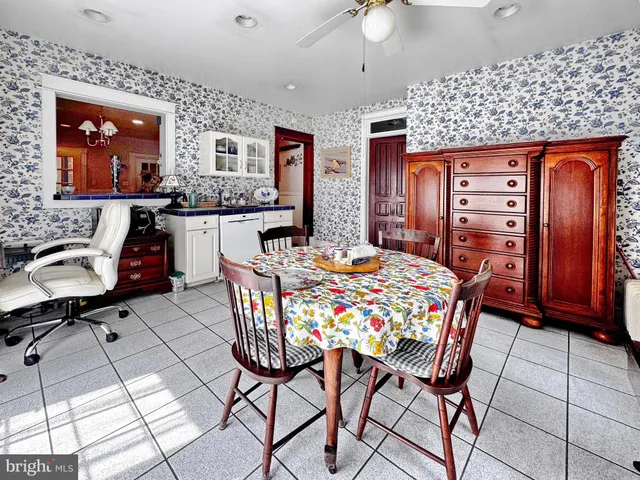 a dining room with furniture and window