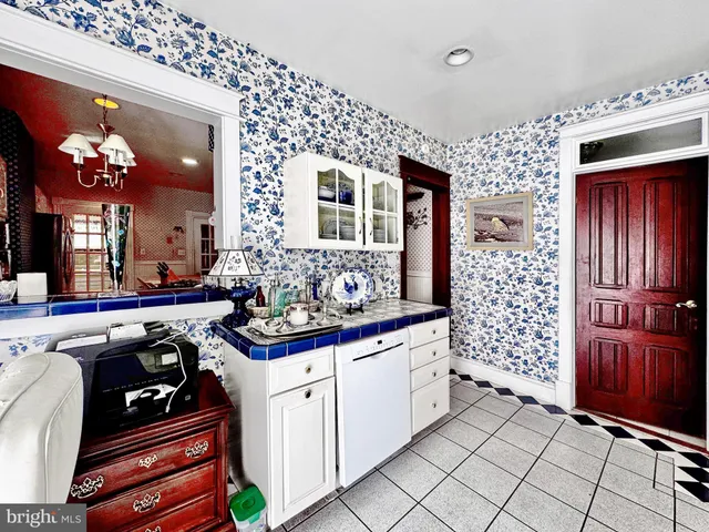 a kitchen with stainless steel appliances kitchen island granite countertop a stove a sink and a cabinets