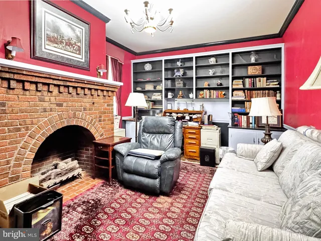 a living room with furniture fireplace and cabinet