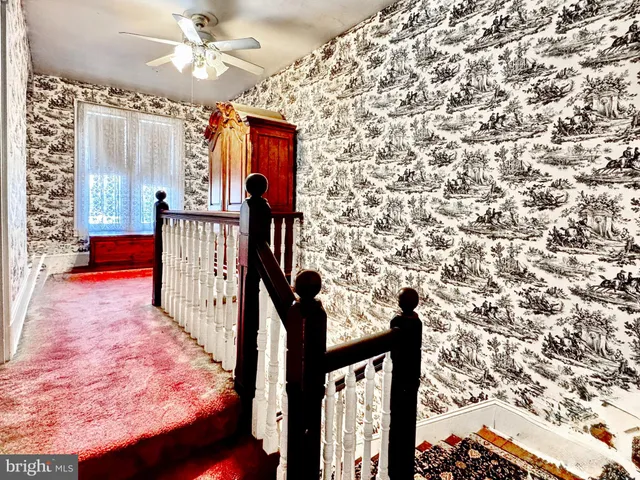 a view of entryway with a front door and wooden floor