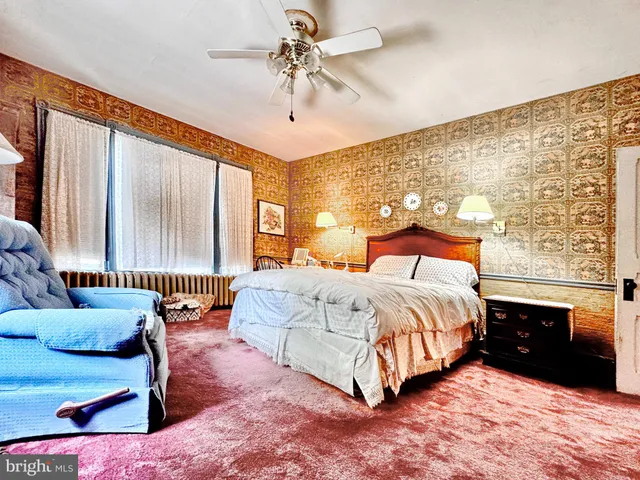 a bedroom with a bed and window