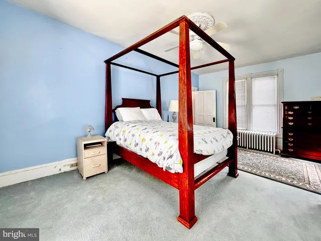 a bedroom with a bed and a ceiling fan