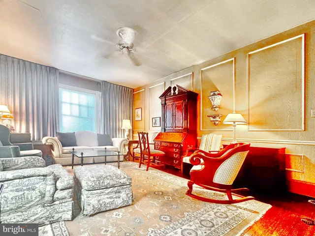 a living room with furniture a rug and a window