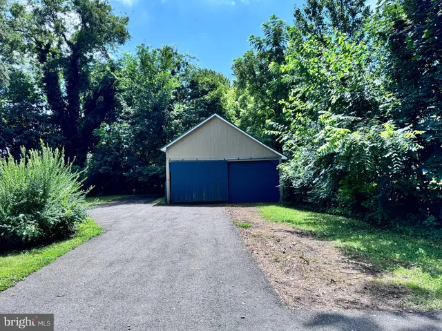 a front view of a house with a yard and tree