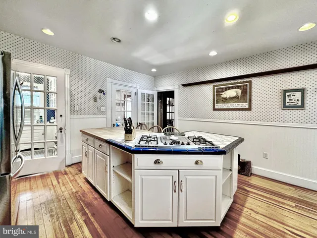 a kitchen with stainless steel appliances granite countertop a stove and a sink