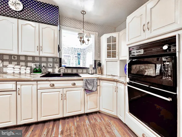 a kitchen with stainless steel appliances a stove a sink and cabinets
