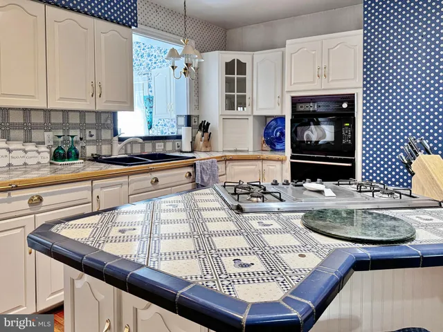 a kitchen with a table and chairs in it