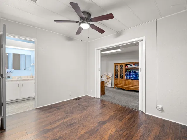 a view of a room wooden floor and a ceiling fan