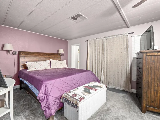 a bedroom with a bed and a mirror