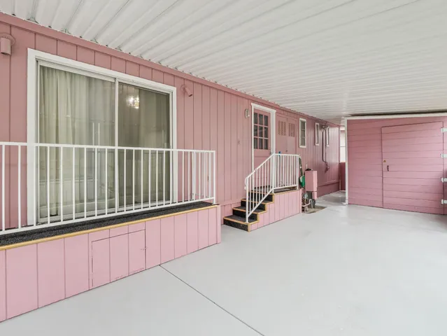 a view of a room with furniture ceiling fan and windows