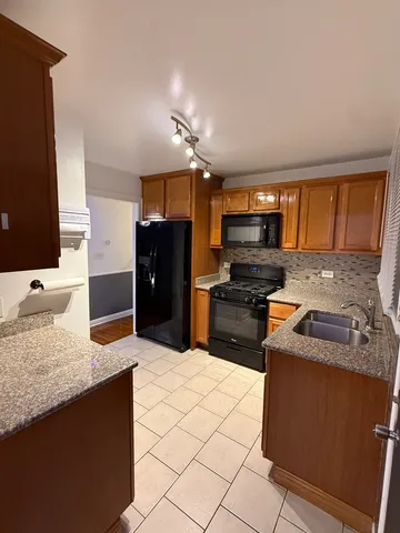 a kitchen with stainless steel appliances granite countertop a refrigerator stove and oven