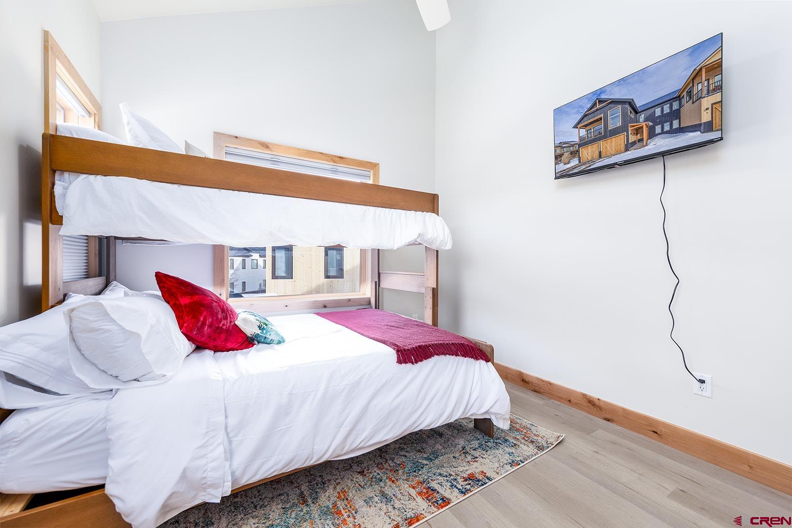 101 Elk Valley Road, Unit A Crested Butte, CO 81224 - Photo 31 of 42 a bedroom with a bed and a painting on the wall