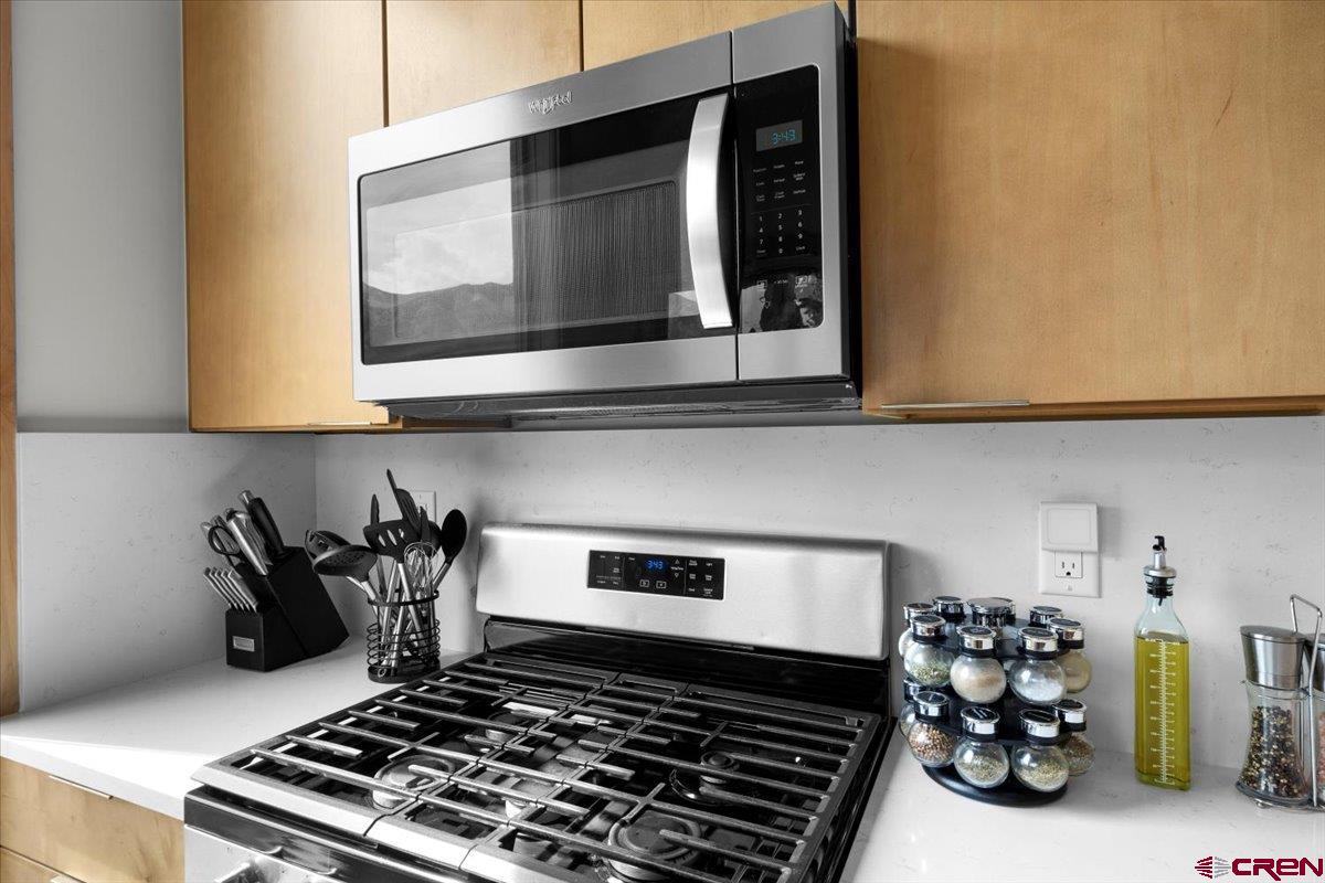 101 Elk Valley Road, Unit A Crested Butte, CO 81224 - Photo 37 of 42 a kitchen with a stove and cabinets