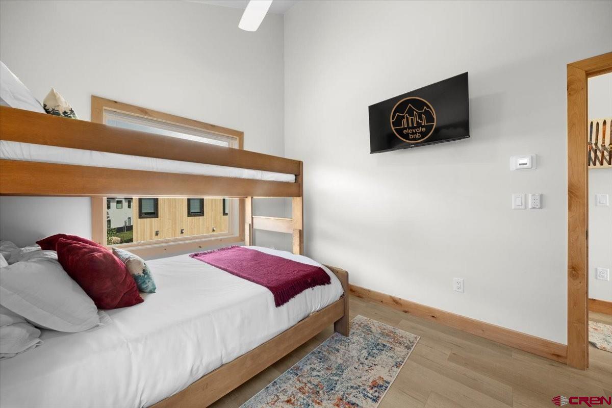 101 Elk Valley Road, Unit A Crested Butte, CO 81224 - Photo 41 of 42 a bedroom with a bed and a wall painting