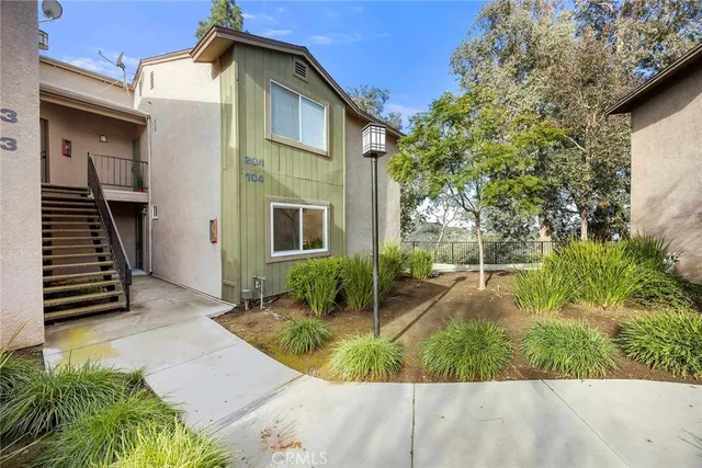 a view of a house with backyard and sitting area