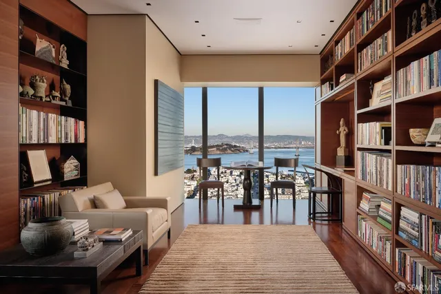 a living room with furniture and a book shelf