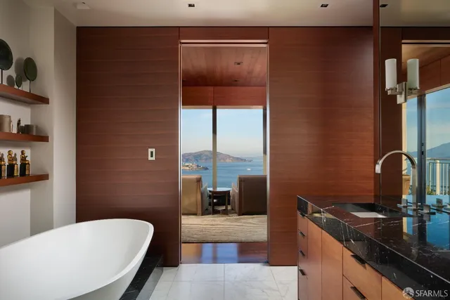 a spacious bathroom with a double vanity sink a mirror a bathtub and shower
