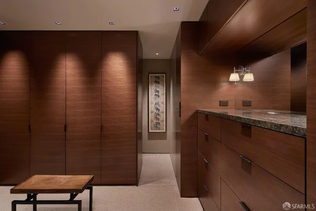 a bedroom with a bed a bookshelf and a flat screen tv