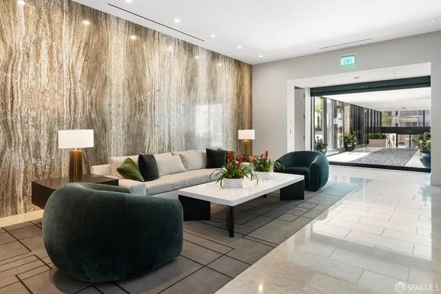 a living room with furniture a flat screen tv and a window