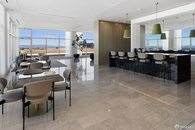 a view of a dining room with furniture and a large window