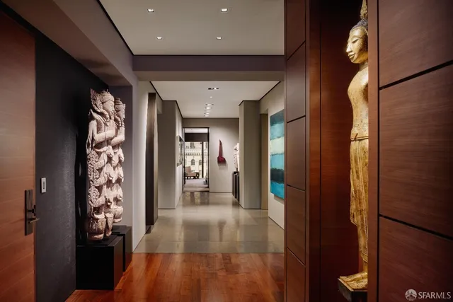 a living room with furniture and a book shelf