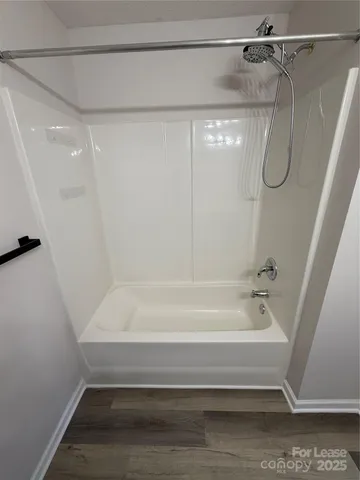 a bathroom with a shower and a bath tub