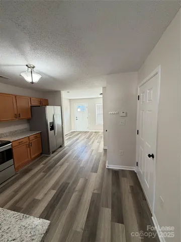 a view of a kitchen with a sink and a refrigerator