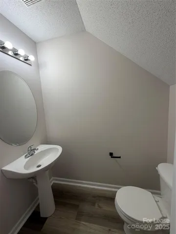 a bathroom with a sink a toilet and mirror