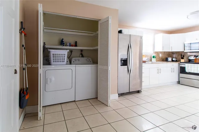 a kitchen with white cabinets and white appliances