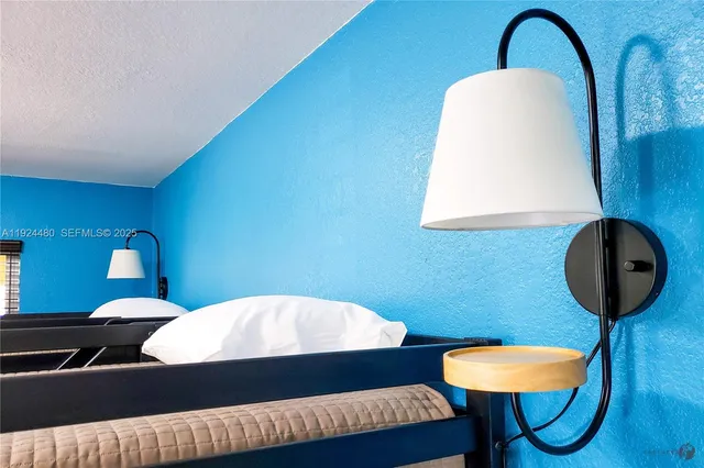 a bedroom with a bed and a potted plant