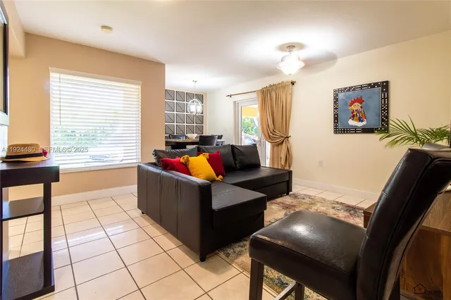 a living room with furniture and a flat screen tv