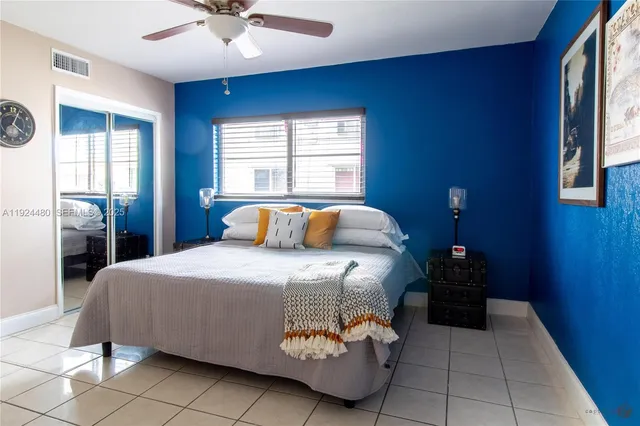 a bedroom with a bed and a ceiling fan