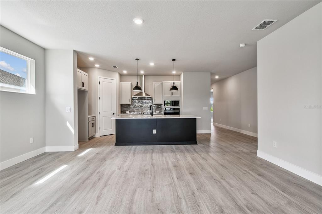 11743 Full Moon Loop Parrish, FL 34219 - Photo 14 of 42 a view of kitchen and kitchen with wooden floor