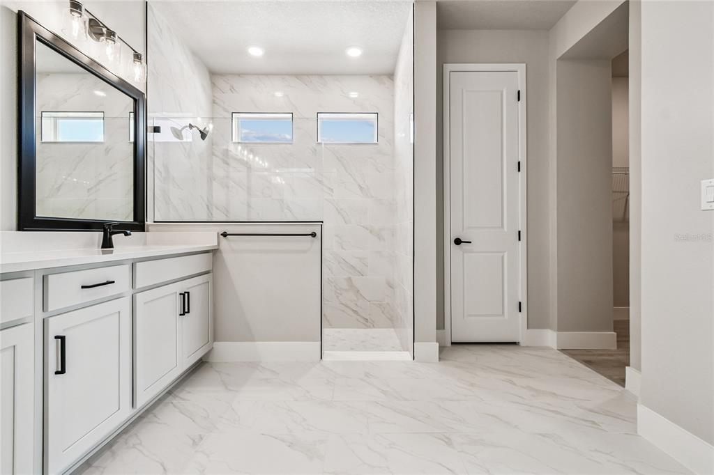 11743 Full Moon Loop Parrish, FL 34219 - Photo 21 of 42 a bathroom with white cabinets and sink