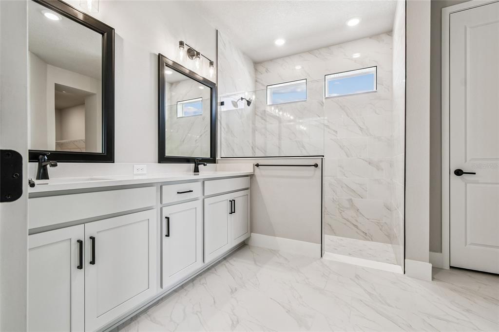 11743 Full Moon Loop Parrish, FL 34219 - Photo 22 of 42 a bathroom with a double vanity sink mirror and