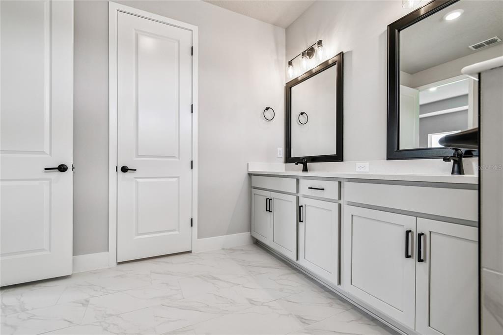 11743 Full Moon Loop Parrish, FL 34219 - Photo 23 of 42 a bathroom with a sink and a mirror