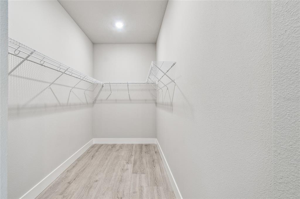 11743 Full Moon Loop Parrish, FL 34219 - Photo 24 of 42 a view of a room with racks on the wall