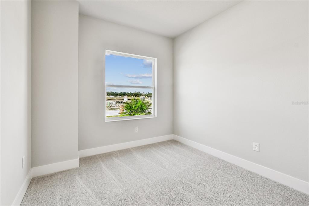 11743 Full Moon Loop Parrish, FL 34219 - Photo 26 of 42 an empty room with windows