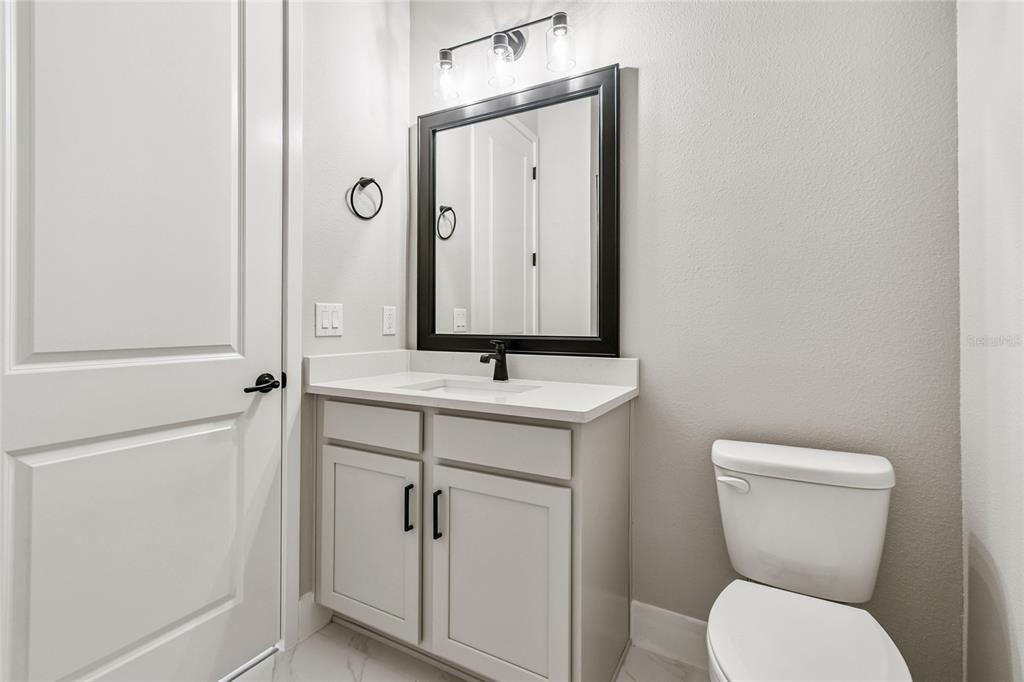 11743 Full Moon Loop Parrish, FL 34219 - Photo 29 of 42 a bathroom with a toilet sink and mirror