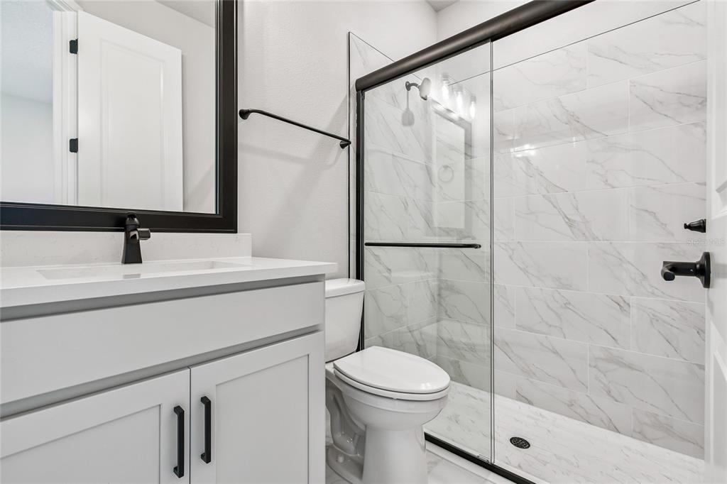 11743 Full Moon Loop Parrish, FL 34219 - Photo 32 of 42 a bathroom with a sink a toilet and shower