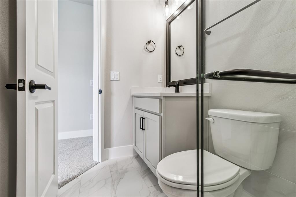 11743 Full Moon Loop Parrish, FL 34219 - Photo 33 of 42 a white toilet sitting next to a bathroom sink