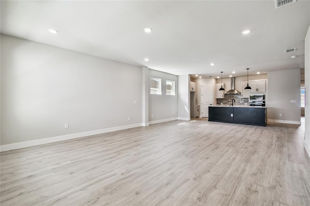 11743 Full Moon Loop Parrish, FL 34219 - Photo 10 of 42 a view of a kitchen with a sink and a refrigerator