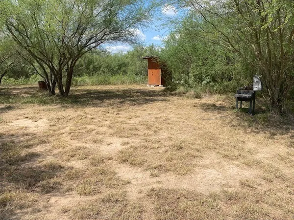 a view of backyard with outdoor seating and green space