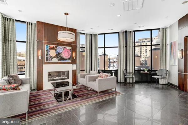 a living room with furniture a rug and a chandelier