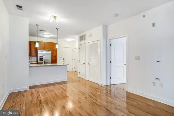 a view of a room with wooden floor and window