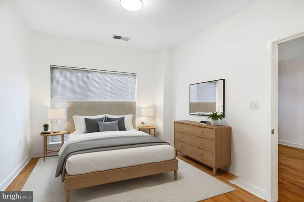 a bedroom with a bed and a night stand