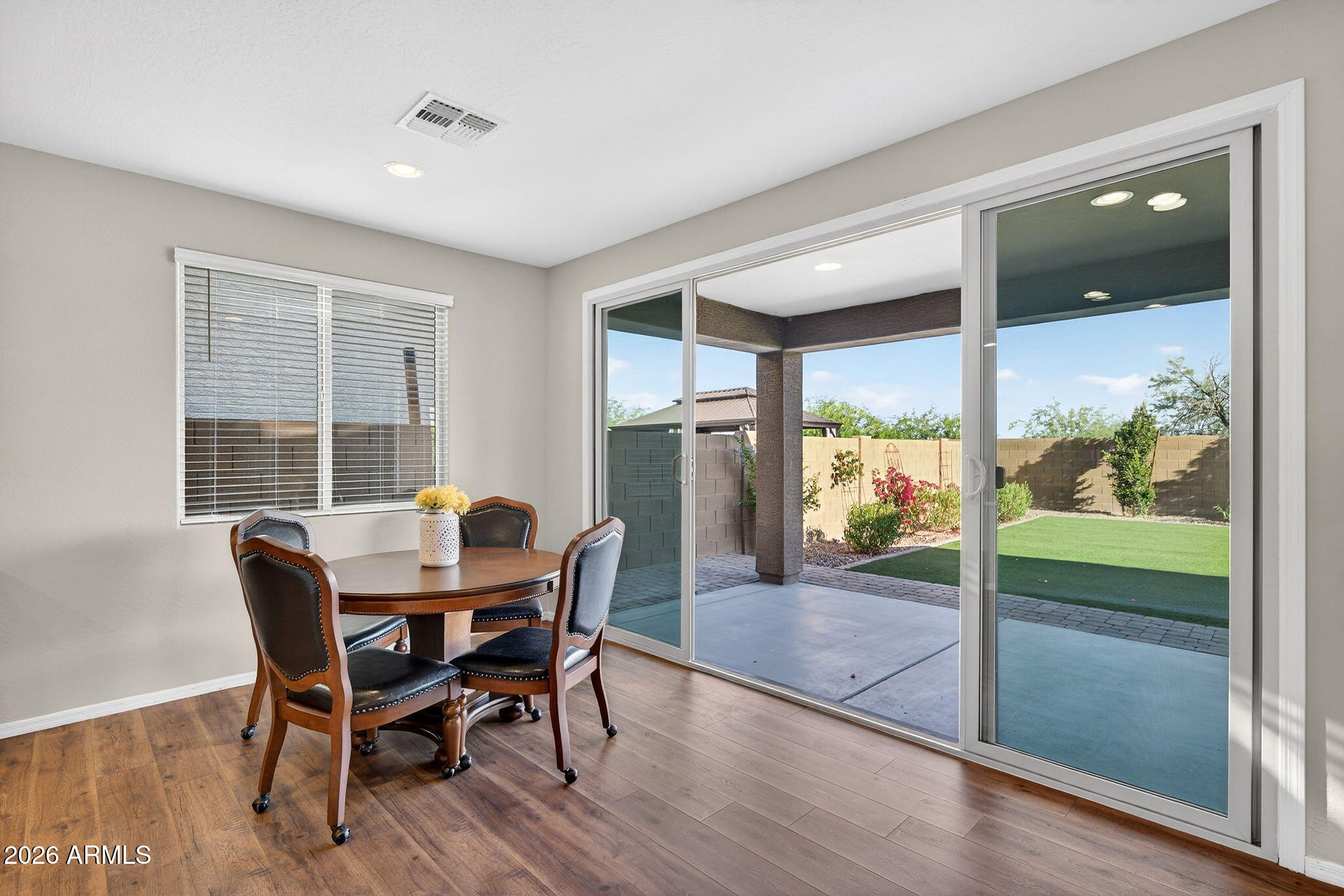 10061 Cotton Road Florence, AZ 85132 - Photo 10 of 53 a view of a dining room with furniture window and wooden floor