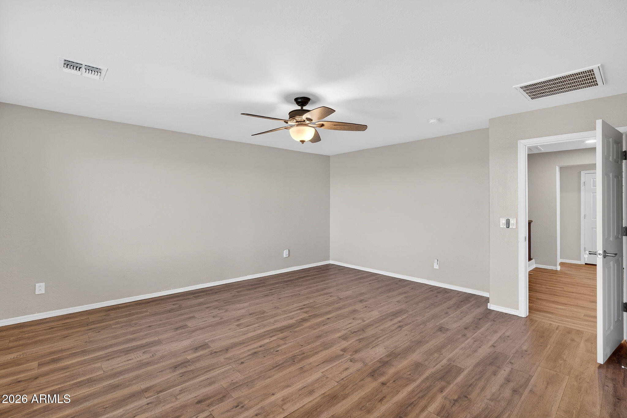 10061 Cotton Road Florence, AZ 85132 - Photo 24 of 53 a view of a room with wooden floor and a ceiling fan