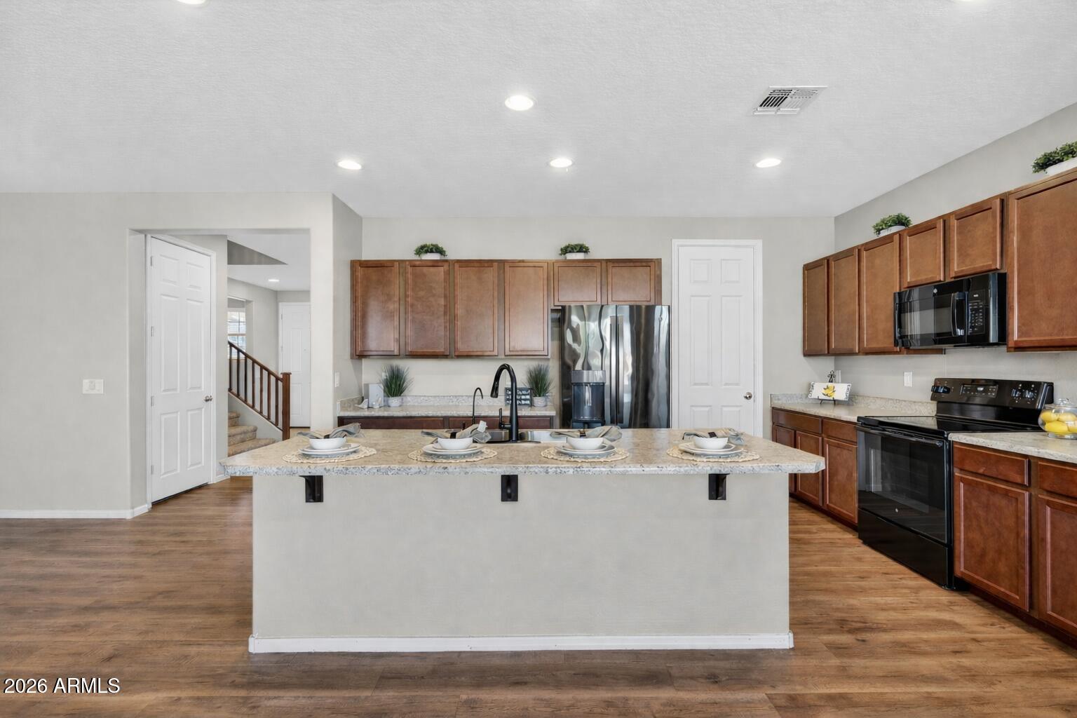 10061 Cotton Road Florence, AZ 85132 - Photo 5 of 53 a view of kitchen with stainless steel appliances granite countertop a stove top oven a sink and a refrigerator